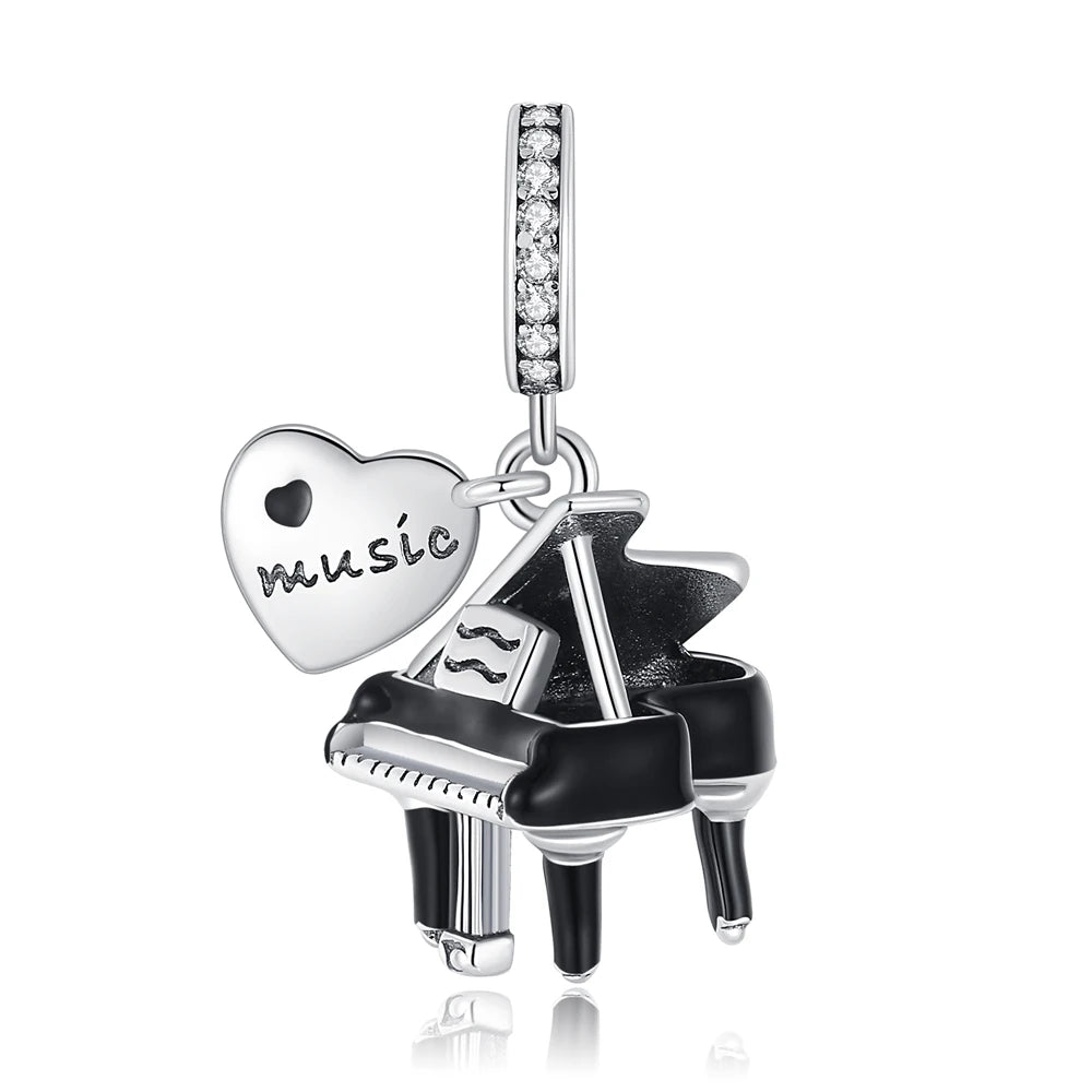 Pendant charm shaped like a piano with a heart and 'music' inscription on a white background Pandora-style charm pendant, musician or music lovers