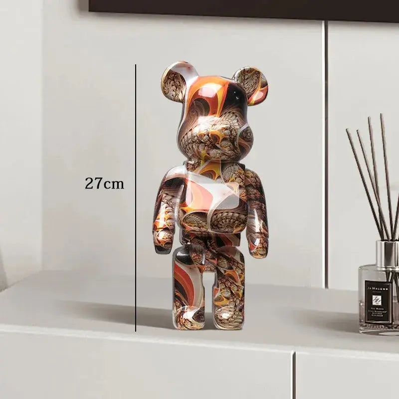 Decorative bear figure with marbled pattern on a white surface next to a diffuser. be@rbrick collectable