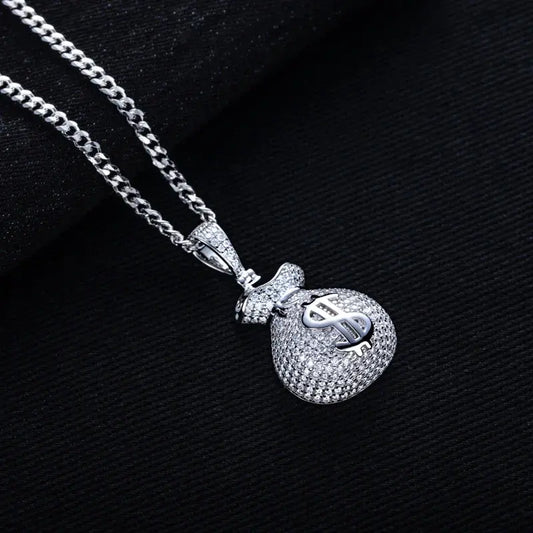 Silver pendant with dollar sign on a chain against a dark background