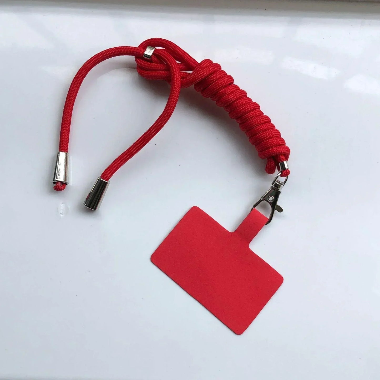 Red lanyard with a red badge holder on a white background