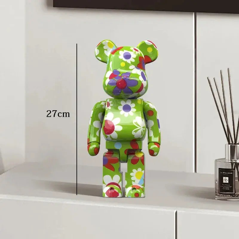 Colorful floral-patterned bear figure on a white surface with a diffuser in the background be@rbrick collectable