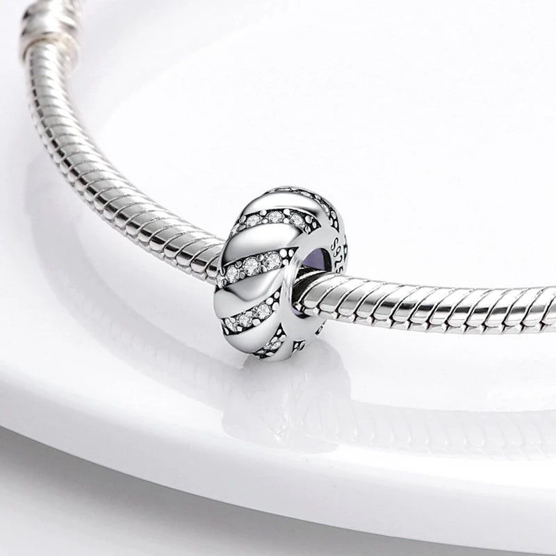 Silver bracelet with a heart-shaped clasp on a white background