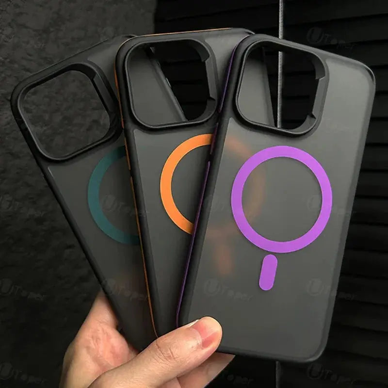 Three phone cases with colorful magnifying glass designs held by a hand against a dark background.