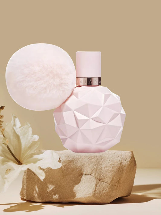 Adrian Grande Pink geometric perfume bottle on a beige rock with a light beige background