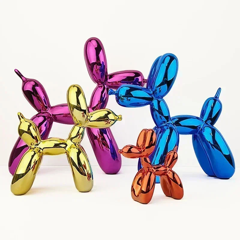 Four colorful balloon dog sculptures in gold, pink, blue, and orange on a white background.