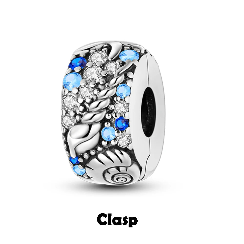 Silver clasp charm with blue and clear stones on a white background