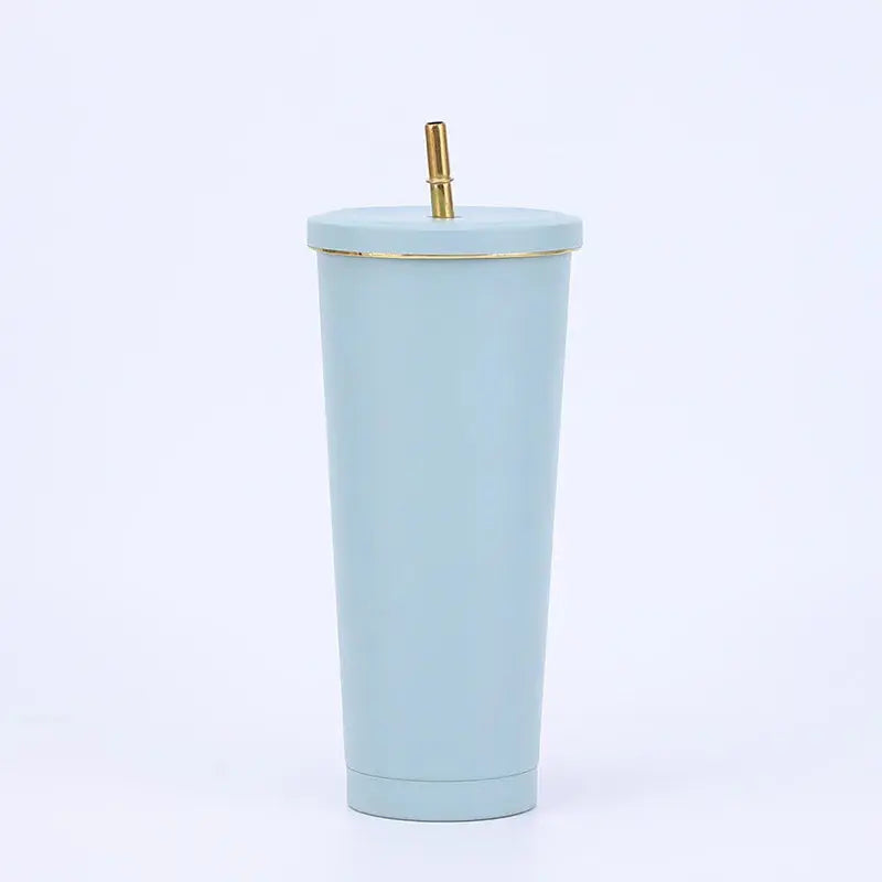 Light blue tumbler with a gold rim and straw on a white background