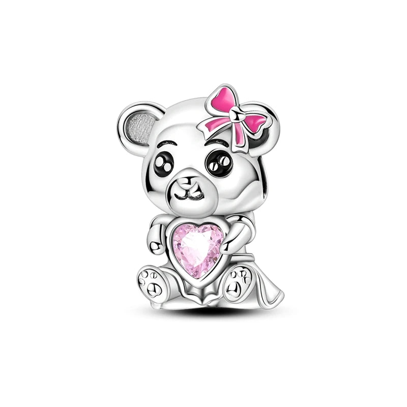 Silver bear charm with pink heart and bow on a white background