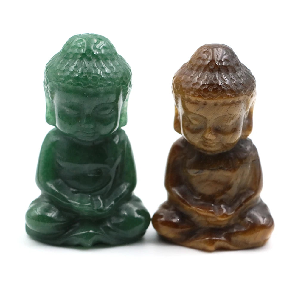 Two small Buddha statues, one green and one brown, on a white background