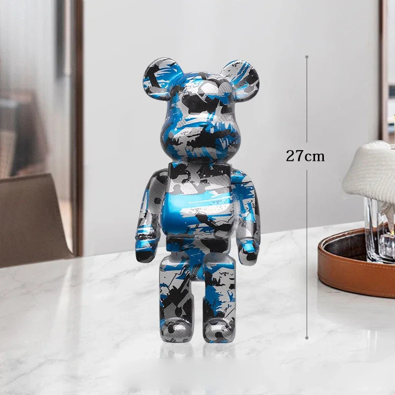 Camouflage-patterned bear figure on a white surface with a measurement label indicating 27cm. be@rbrick collectable