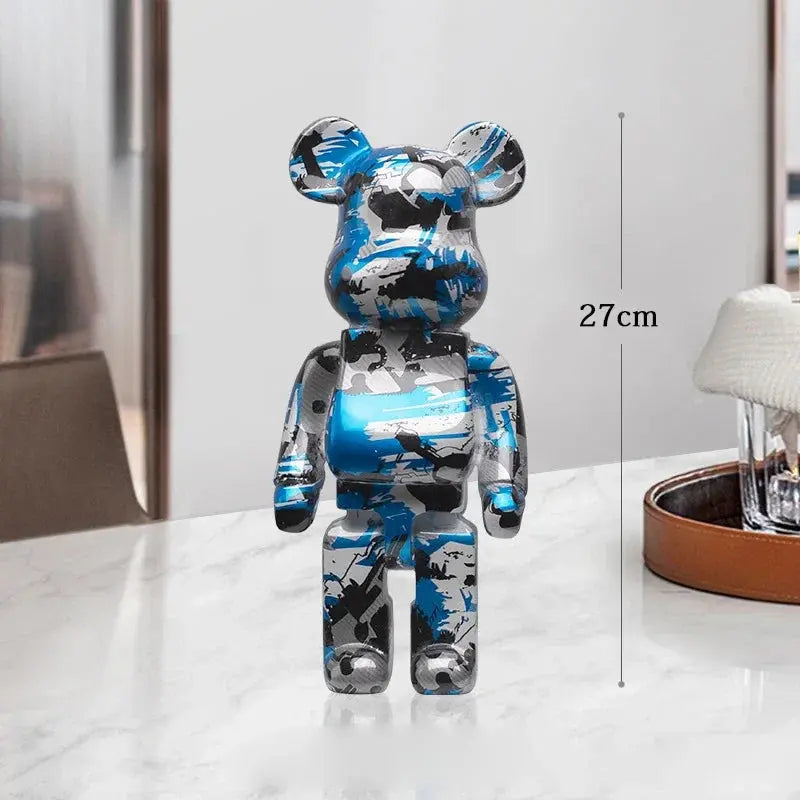Camouflage-patterned bear figure on a white surface with a measurement label indicating 27cm. be@rbrick collectable