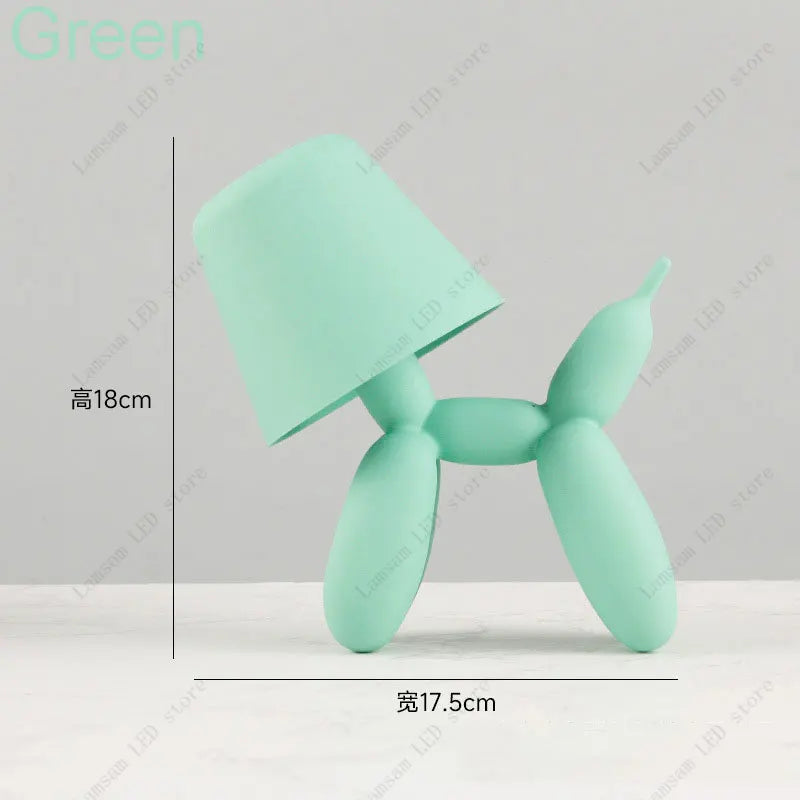 Green dog-shaped toy with measurements on a gray background