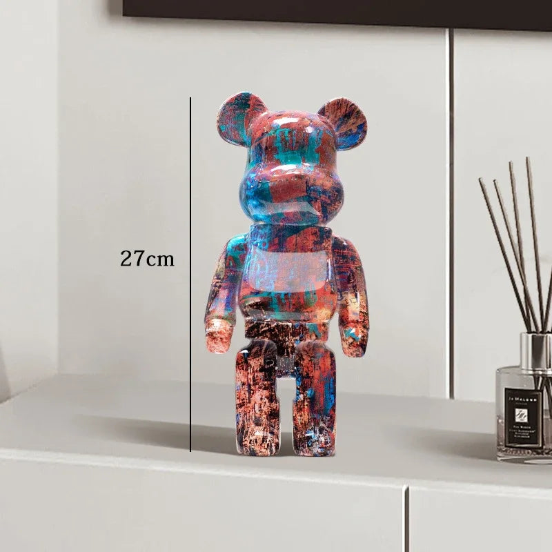 Colorful bear-shaped figure on a white surface with a measurement label, next to a diffuser. be@rbrick collectable
