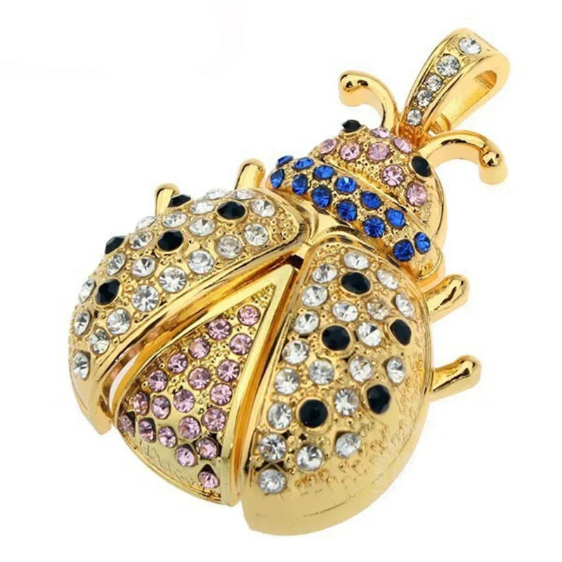 Gold ladybug pendant with colorful gemstones on a white background