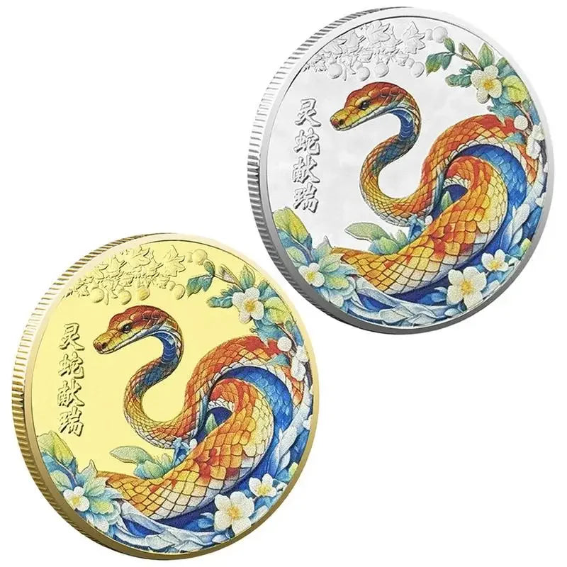 A collectible coin with a 3D relief design of a snake and floral patterns, predominantly in gold and silver colors.
