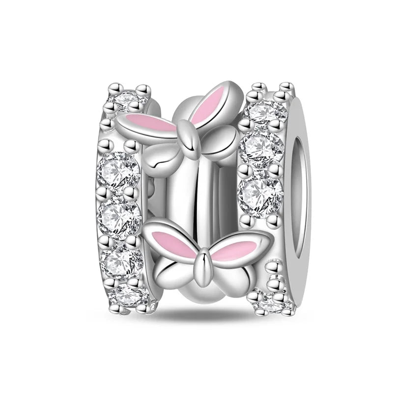 Silver butterfly charm with pink accents and clear stones on a white background