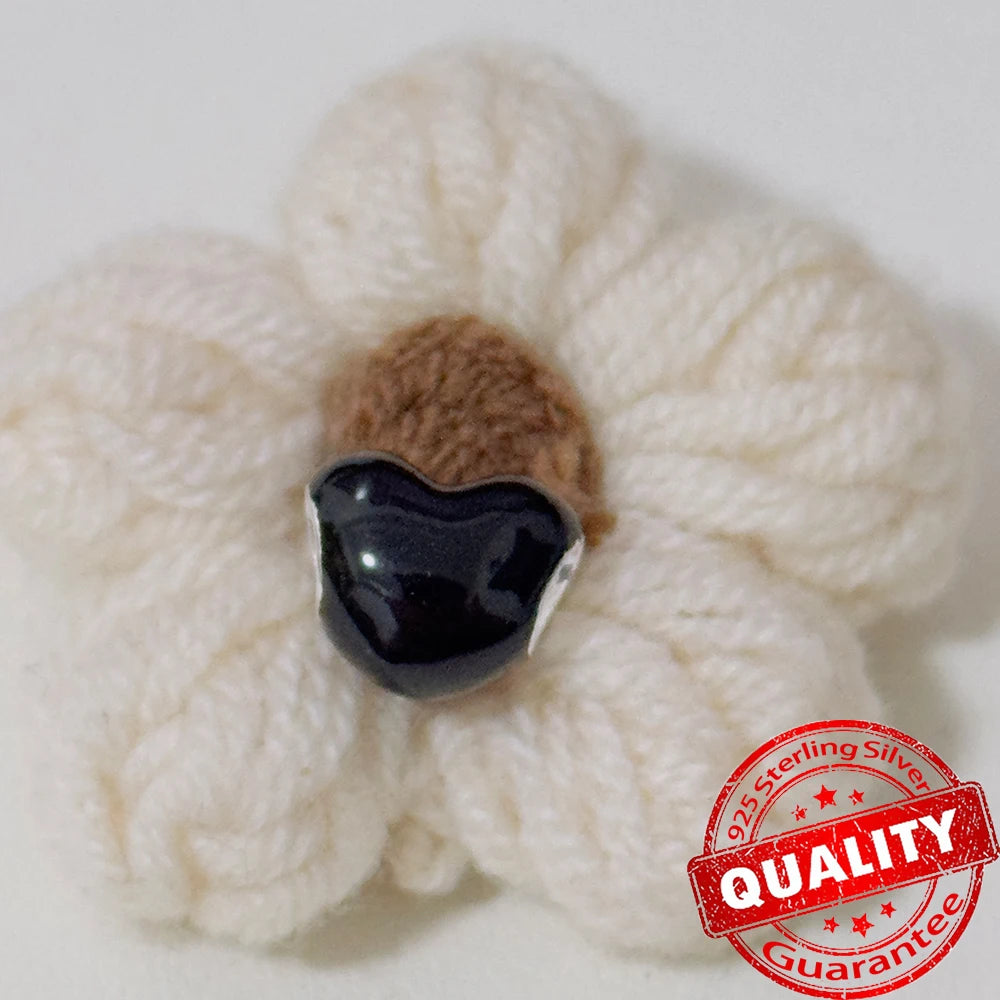 White knitted flower with a black center on a white background, featuring a '925 Sterling Silver' quality guarantee stamp. Black heart. pandora style charm pendant. Gothic style, halloween theme