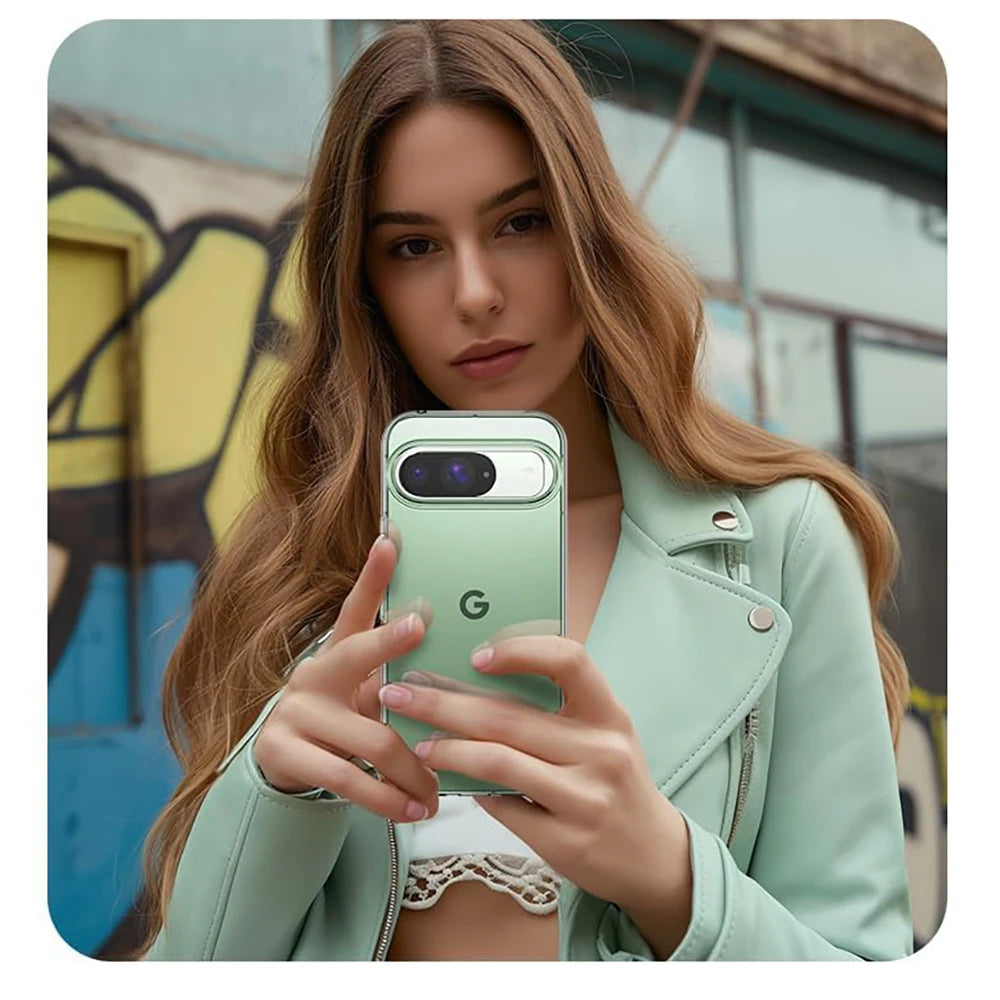 Woman holding a smartphone with a green case against a colorful wall.