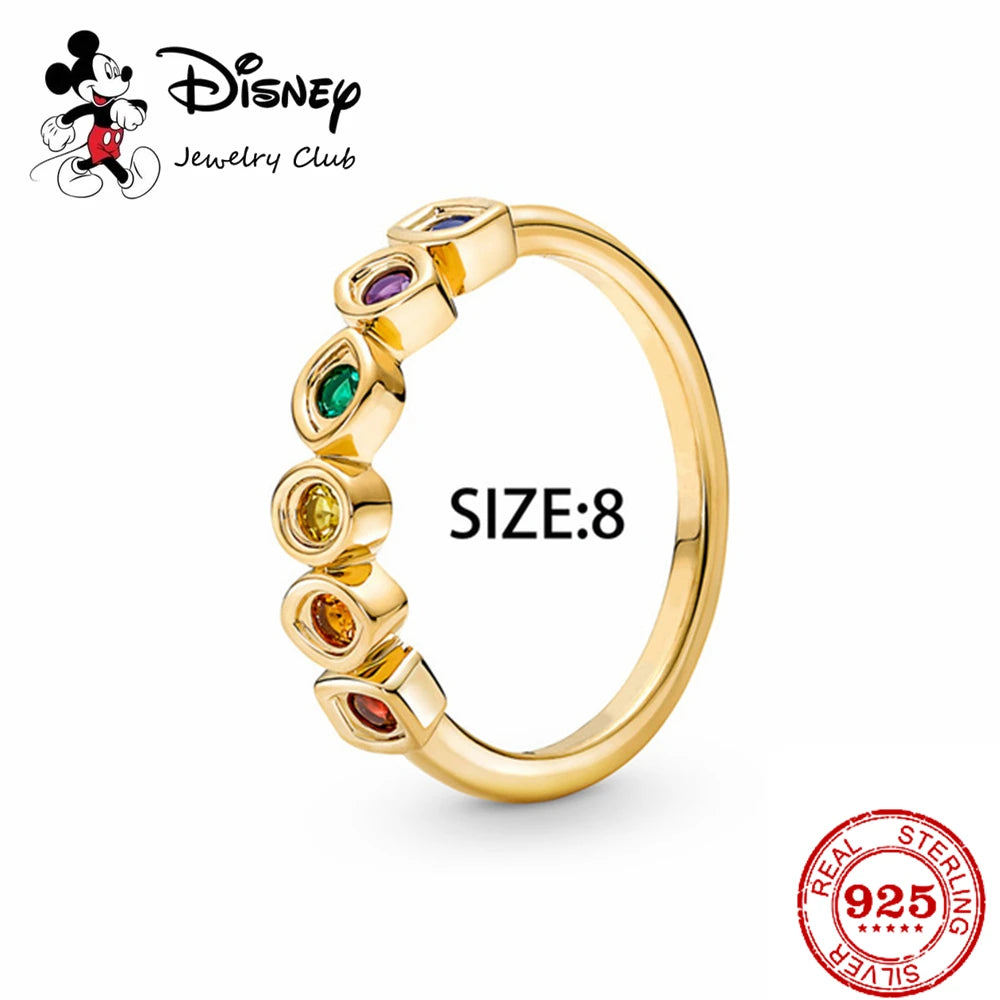Gold ring with colored stones and Disney Jewelry Club logo on a white background