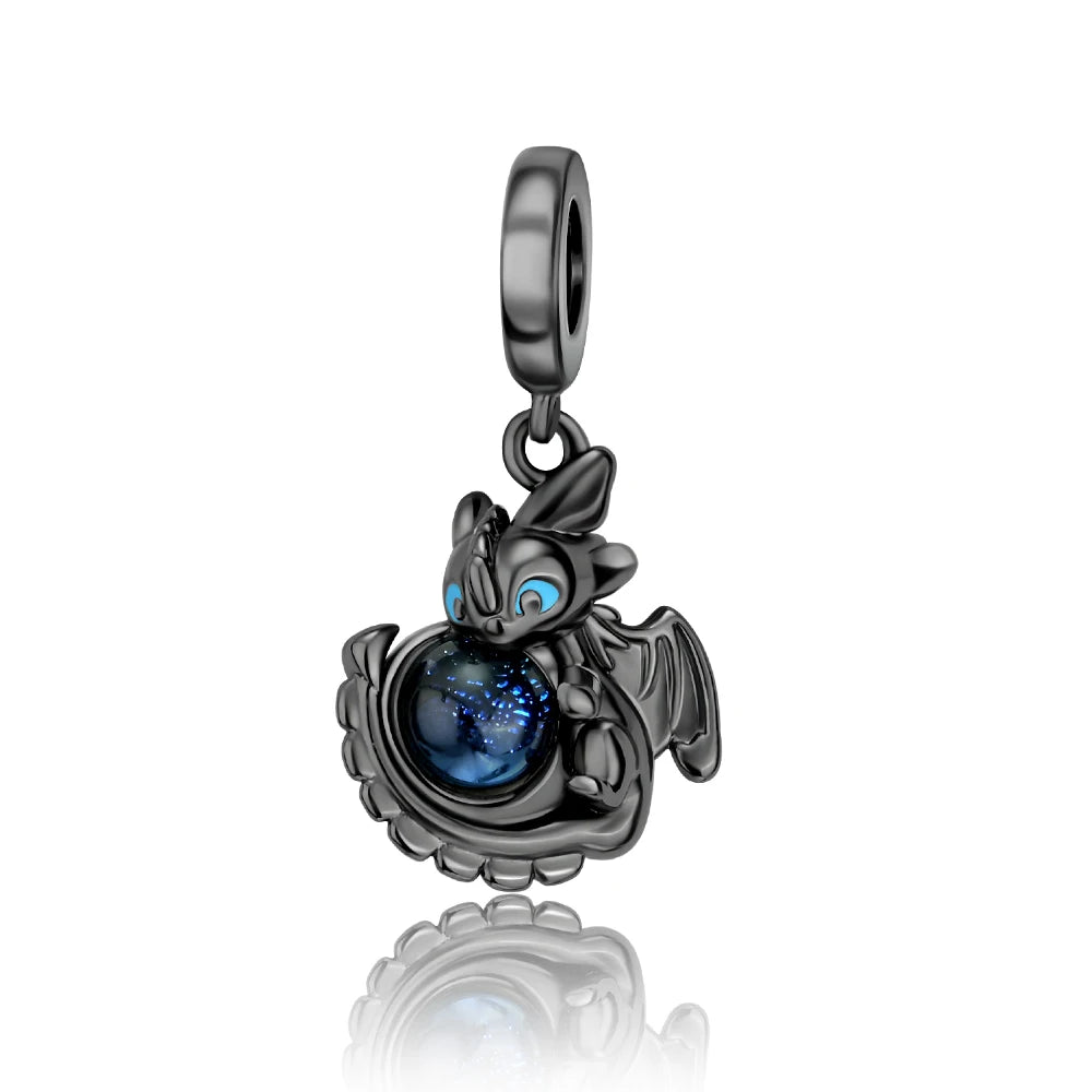 Dragon-shaped pendant with blue gem on a white background. pandora style charm pendant. Gothic style, halloween theme