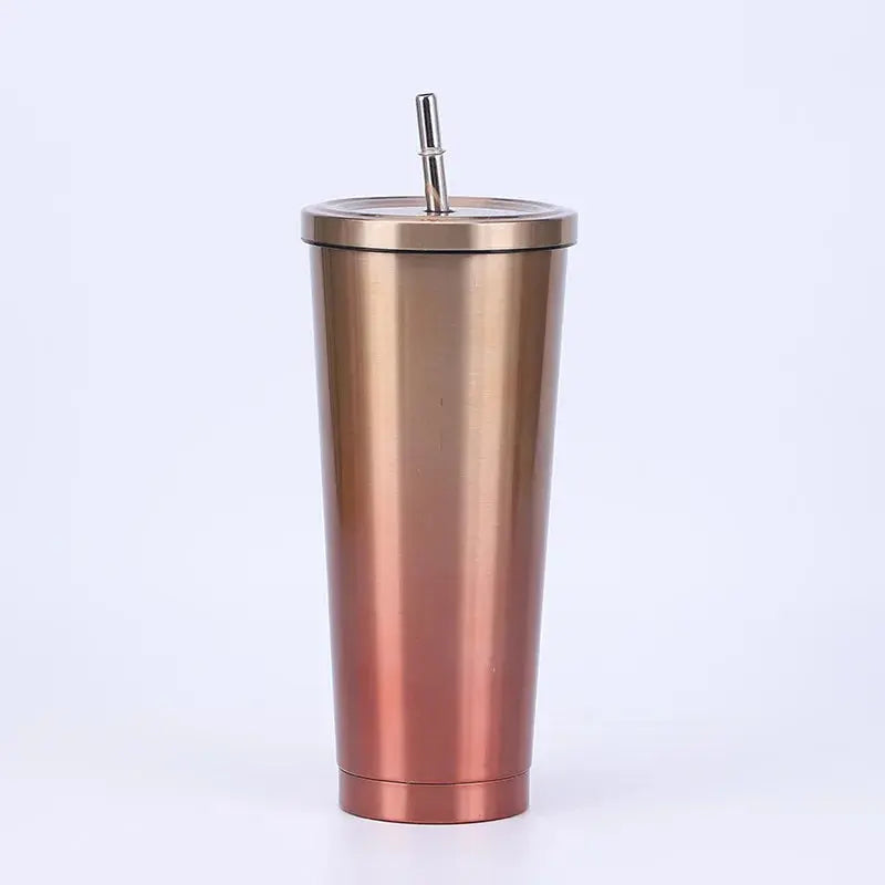 Rose gold tumbler with a straw on a white background