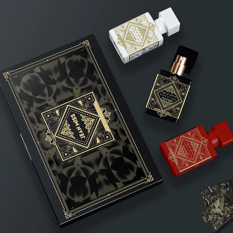 Decorative book, perfume bottles, and packaging on a dark background