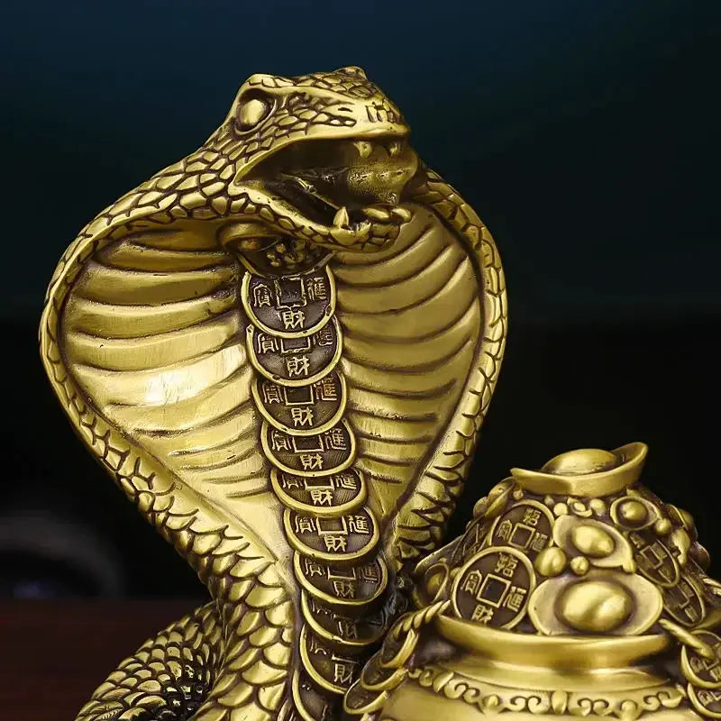 A bronze colored metal ornament in the shape of a snake coiled around a pot with Chinese characters inscribed, representing the Twelve Zodiac Snakes theme.