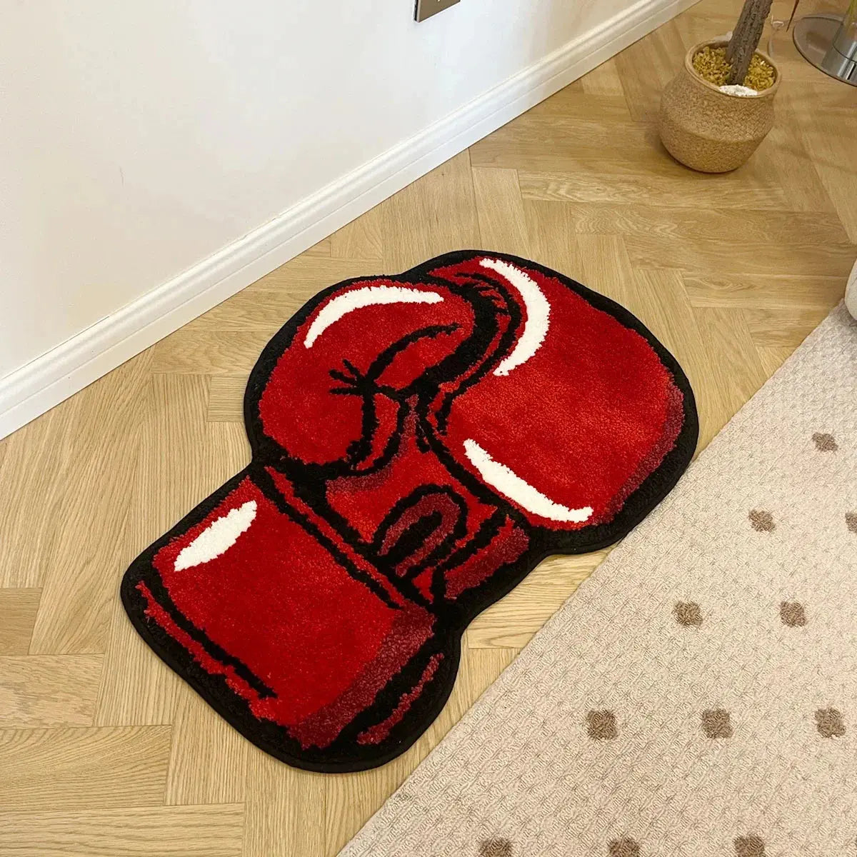 Red boxing glove rug on a wooden floor