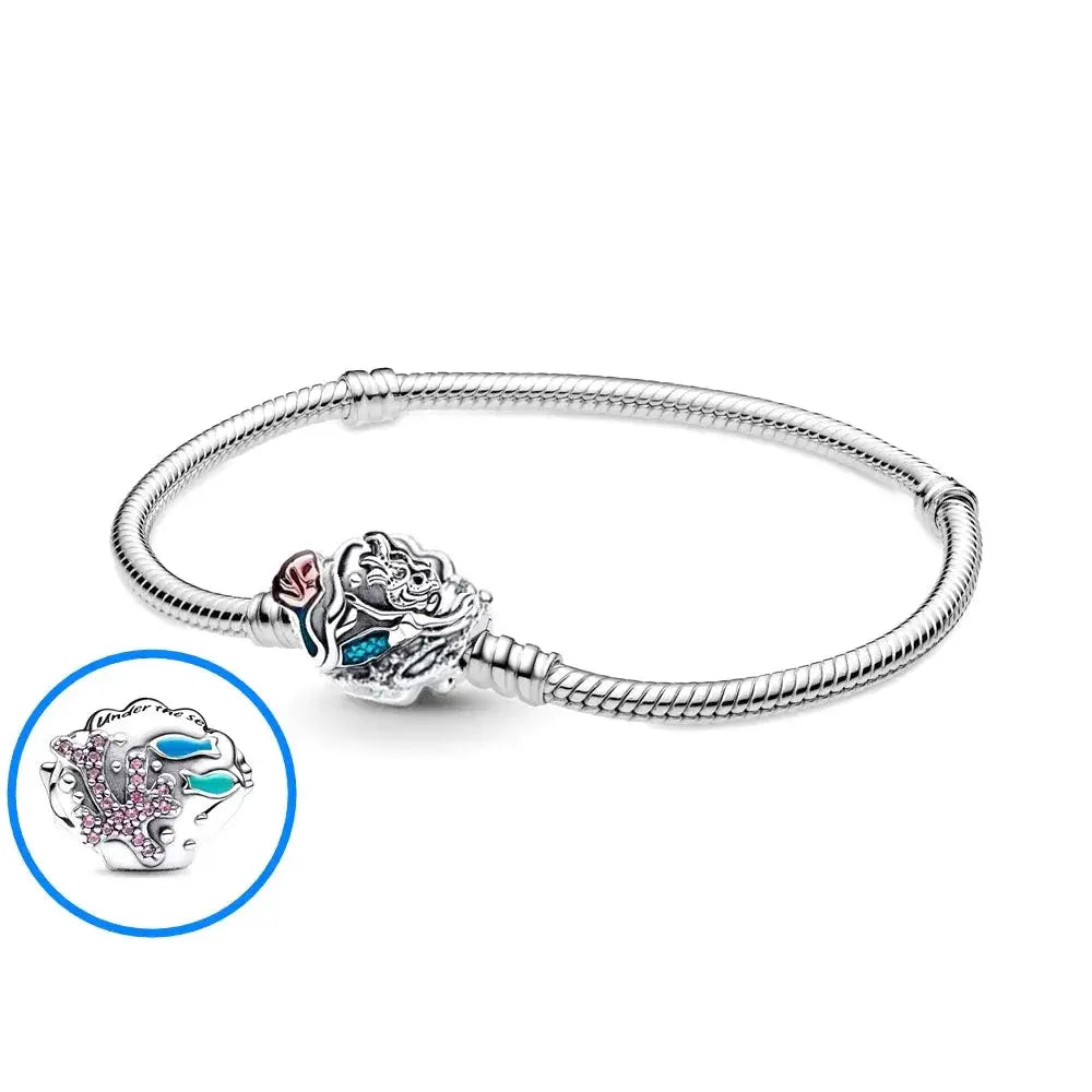 Silver bracelet with a detailed charm on a white background