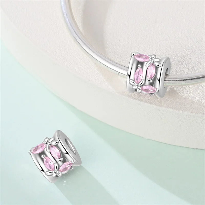 Silver bracelet with pink gemstone beads on a light background. pandora style