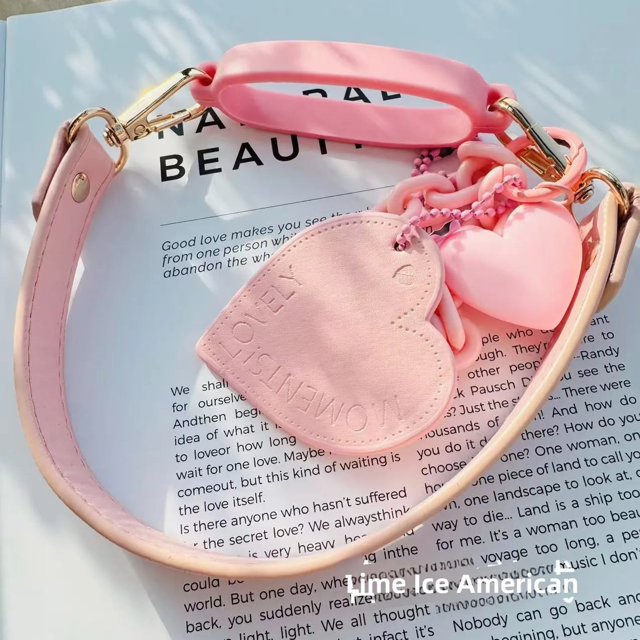 stnley Pink handbag with heart-shaped pouch on a magazine page