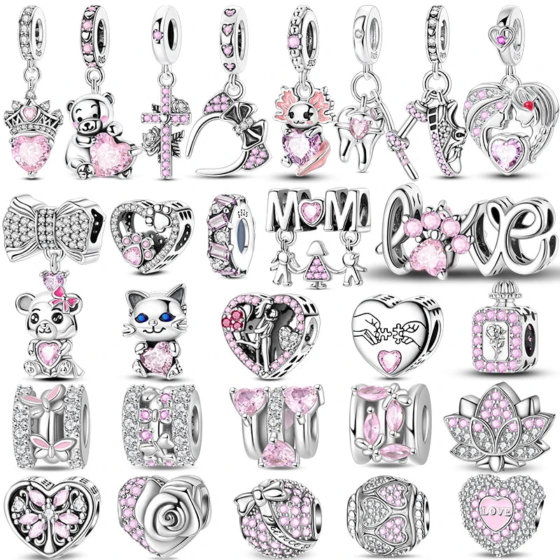 Collection of various silver and pink charms on a white background. pandora style