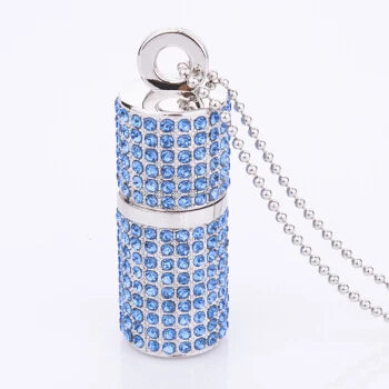 Decorative cylindrical object with blue gemstones and a chain on a white background