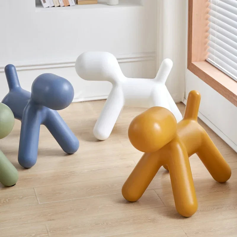 Colorful children's chairs shaped like dogs on a wooden floor.