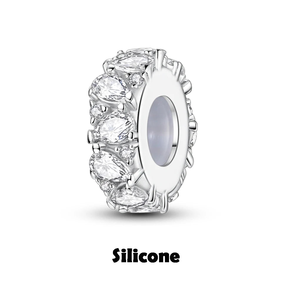 Silver charm with clear stones on a white background, labeled 'Silicone'.
