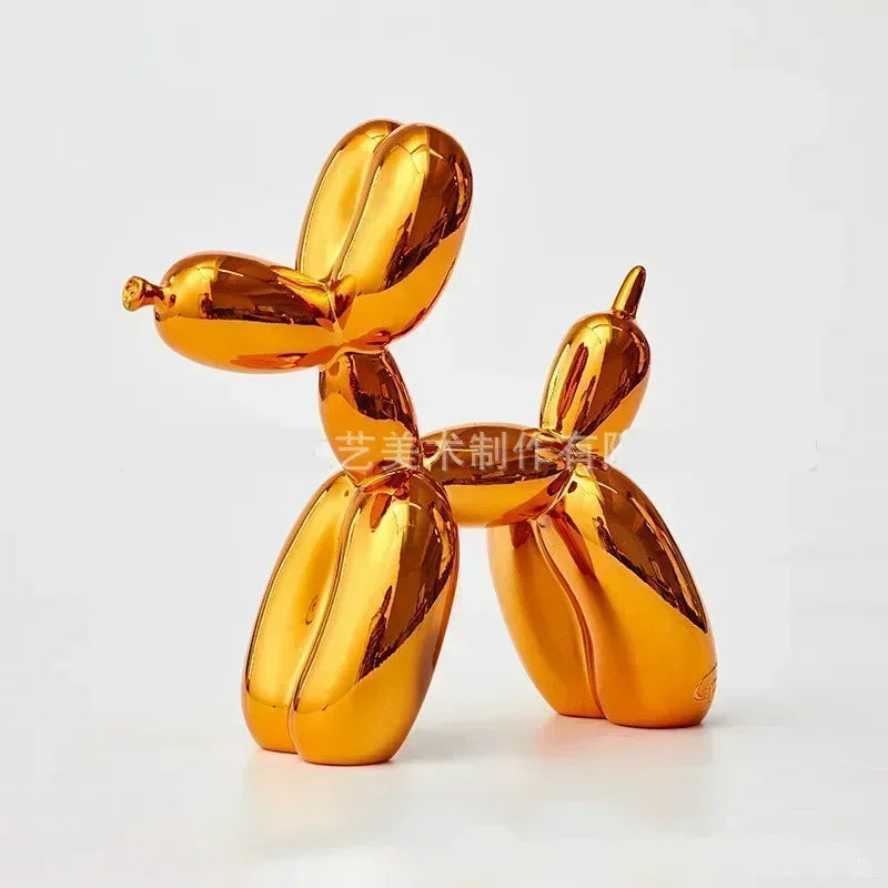 Gold balloon dog sculpture on a white background