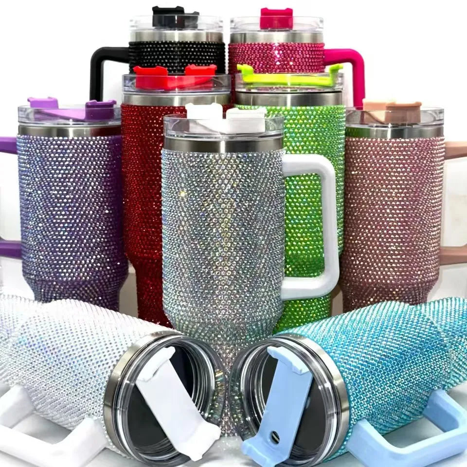 Collection of colorful blinged-out tumblers with handles on a white background