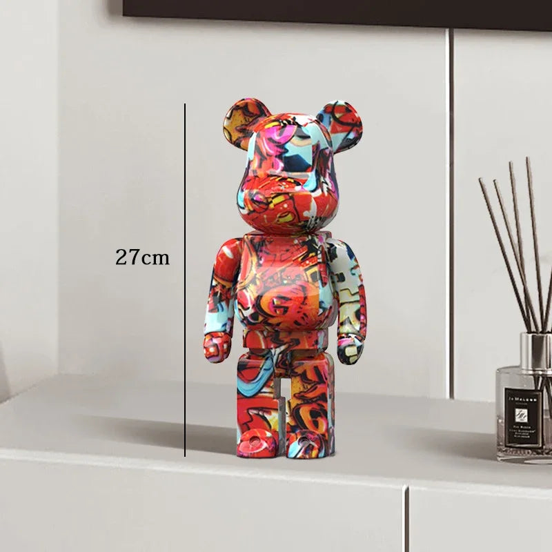 Colorful bear-shaped figure on a white surface with a measurement be@rbrick collectablelabel