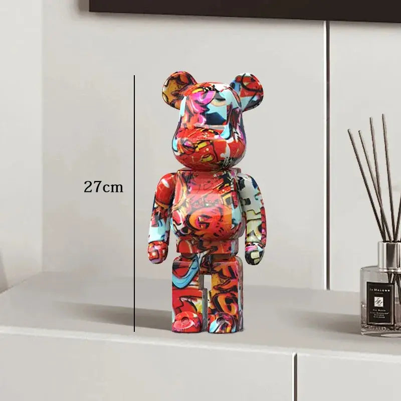 Colorful bear-shaped figure on a white surface with a measurement be@rbrick collectablelabel
