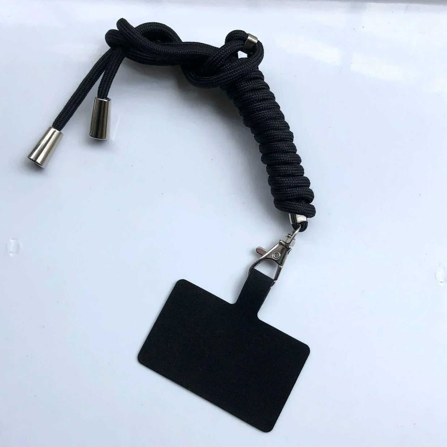 Black lanyard with a clip and badge holder on a white background
