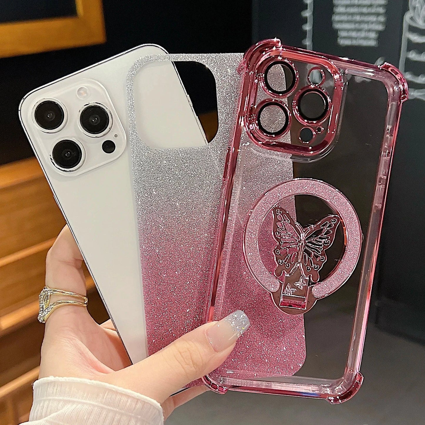 Pink glittery phone case with butterfly design held by a hand