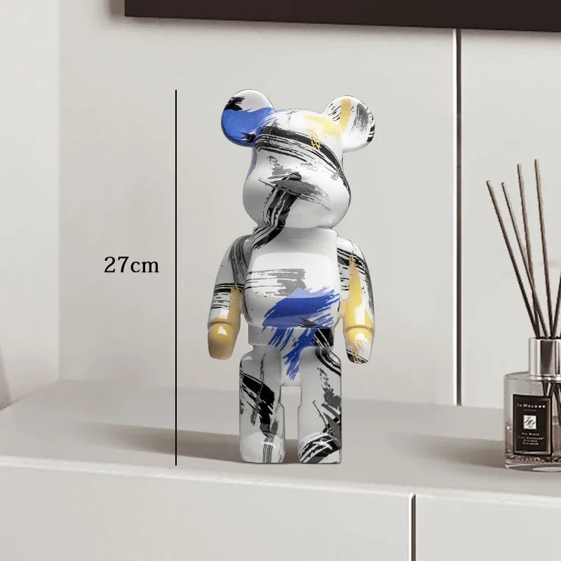 Decorative figure with abstract design on a shelf next to a diffuser be@rbrick collectable