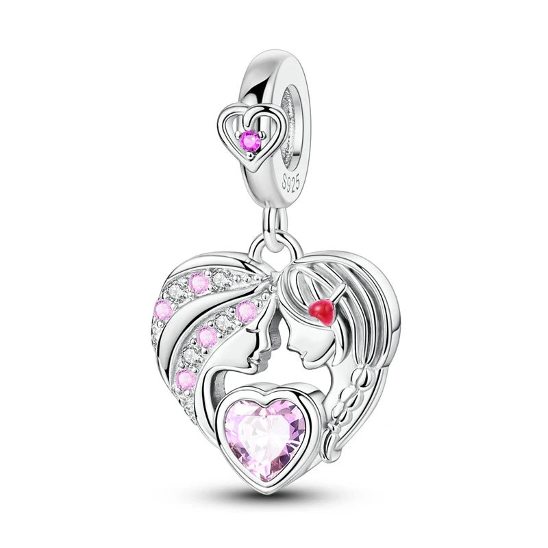 Heart-shaped silver pendant with pink and red gemstones on a white background