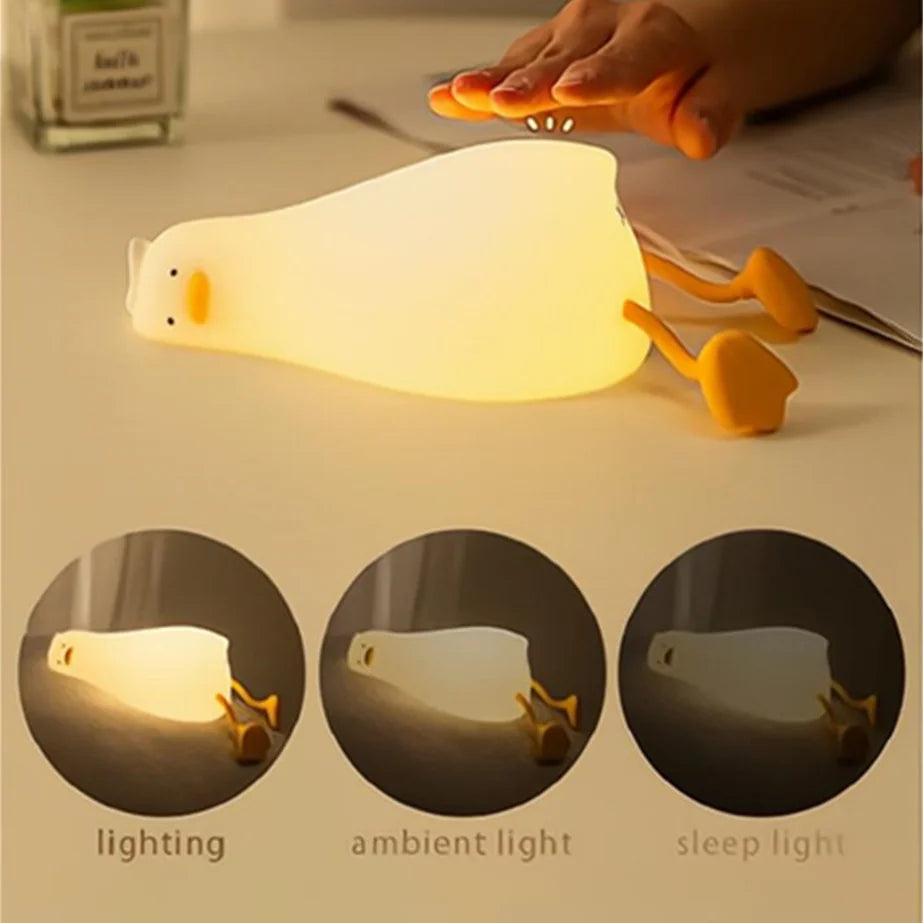 Cat-shaped night light with different lighting modes on a table.