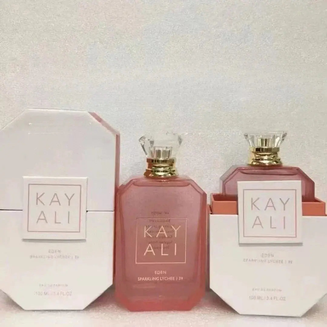 Two bottles of Kayali perfume with packaging on a light background
