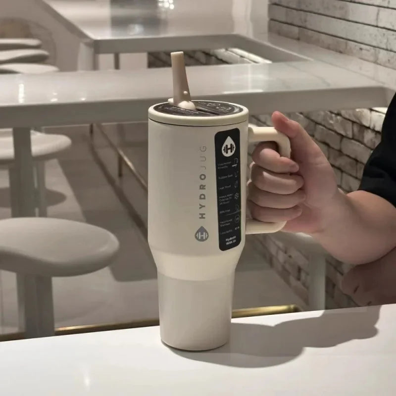 Beige HydroJug Gobelet 40OZ Voyageur Thermos with flip straw in use, highlighting its ergonomic and user-friendly design.
