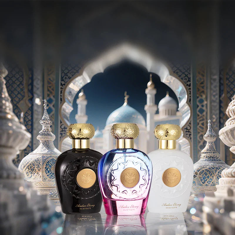 Three perfume bottles with gold caps in front of a decorative archway.