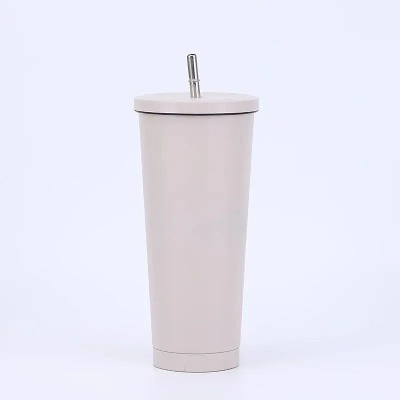 Beige tumbler with a straw on a white background