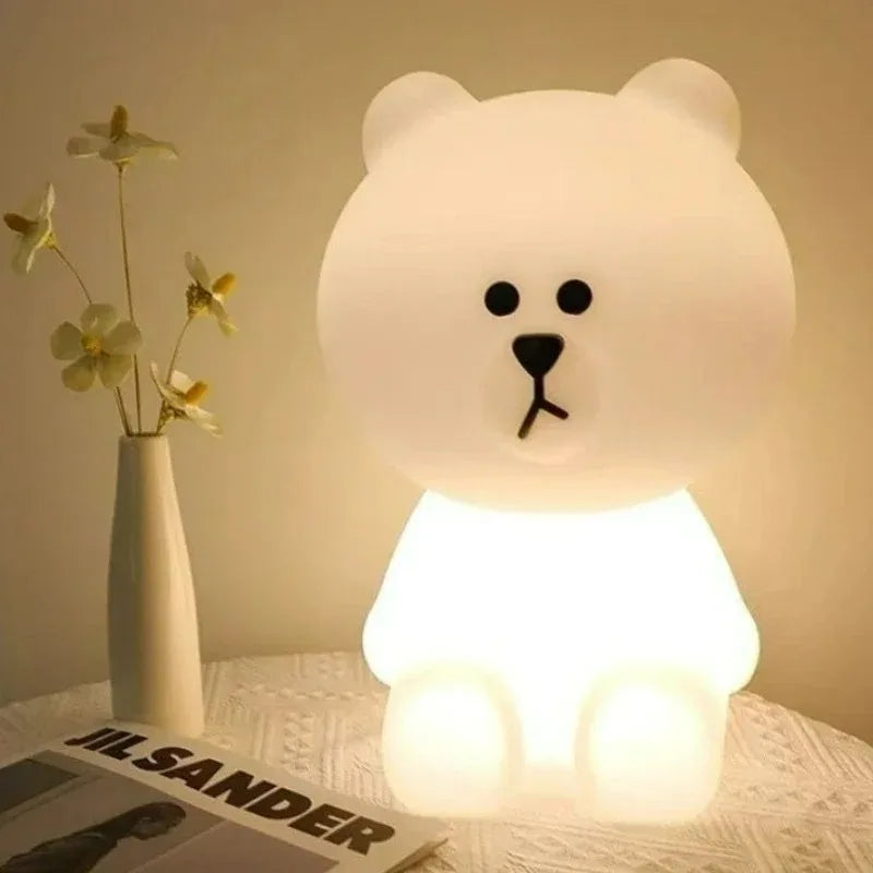 White bear-shaped lamp on a surface with a vase and newspaper in the background
