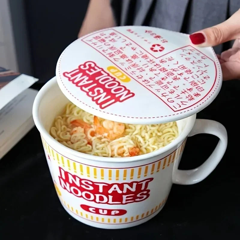 Close-up of red ceramic noodle bowl with lid being lifted. Keeps noodles hot and is perfect for quick, stylish meals.